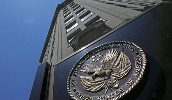 This June 21, 2013, file photo shows the seal affixed to the front of the Department of Veterans Affairs building in Washington. (AP Photo/Charles Dharapak, File)