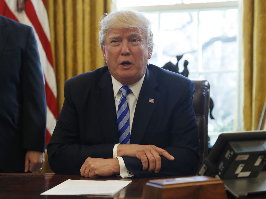 President Donald Trump meets with members of the media regarding the health care overhaul bill, Friday, March 24, 2017, in the Oval Office of the White House in Washington. (AP Photo/Pablo Martinez Monsivais)
