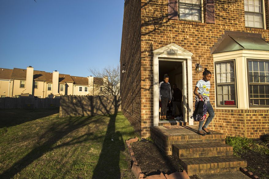 ADVANCE FOR MONDAY, MARCH 27, 2017 -In this Tuesday, Feb. 28, 2017 photo, Kyliegh Hadaway heads out the front door in Virginia Beach, Va., and into a cab that will take her to school at Green Run Elementary School where she is in the 5th grade. Her family was displaced by Hurricane Matthew and now lives in a different school district but Kyliegh and her older sister Trenyce Hadaway are attending their original schools until the end of the school year. (Bill Tiernan/The Virginian-Pilot via AP)
