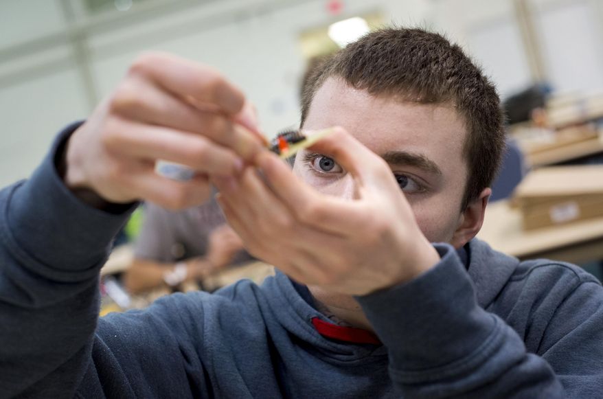 FOR RELEASE SATURDAY, MARCH 25, 2017, AT 9:00 A.M. EDT.= Heritage High School student John Kerelejza works on the circuit board of the drone he was building during intersession on Tuesday, Feb. 27, 2017. The students used their intersession week off of school to build the drones. (Jill Nance /News & Daily Advance via AP)
