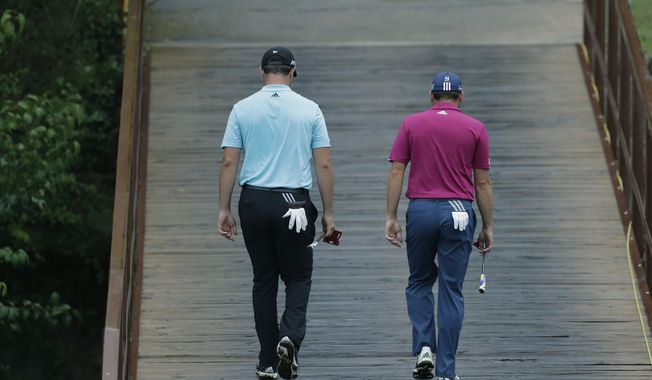 Sergio Garcia, of Spain, right, walks with compatriot and playing partner Jon Rahm on the third hole during round-robin play at the Dell Technologies Match Play golf tournament at Austin County Club, Friday, March 24, 2017, in Austin, Texas. (AP Photo/Eric Gay)