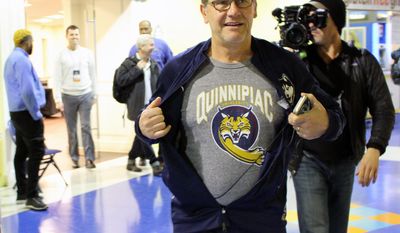 UConn coach Geno Auriemma displays a Quinnipiac University T-shirt before his team&#39;s Sweet 16 NCAA women&#39;s college basketball practice in Bridgeport, Ct., Friday, March 24, 2017. This is the first year both Connecticut schools have made it as far as the NCAA regional semifinals. (AP Photo/Pat Eaton-Robb)