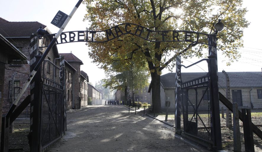 File - In this Oct. 19, 2012 file photo the entrance with the inscription "Arbeit Macht Frei" (Work Sets You Free) gate of the former German Nazi death camp of Auschwitz is seen at the Auschwitz-Birkenau memorial in Oswiecim, Poland. A group of nearly a dozen people took off their clothes, killed a sheep and chained themselves together by the gate before being detained by police, Friday, March 24, 2017. (AP Photo/Czarek Sokolowski,file)