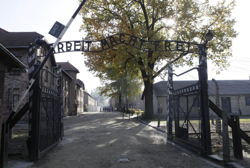 File - In this Oct. 19, 2012 file photo the entrance with the inscription "Arbeit Macht Frei" (Work Sets You Free) gate of the former German Nazi death camp of Auschwitz is seen at the Auschwitz-Birkenau memorial in Oswiecim, Poland. A group of nearly a dozen people took off their clothes, killed a sheep and chained themselves together by the gate before being detained by police, Friday, March 24, 2017. (AP Photo/Czarek Sokolowski,file)