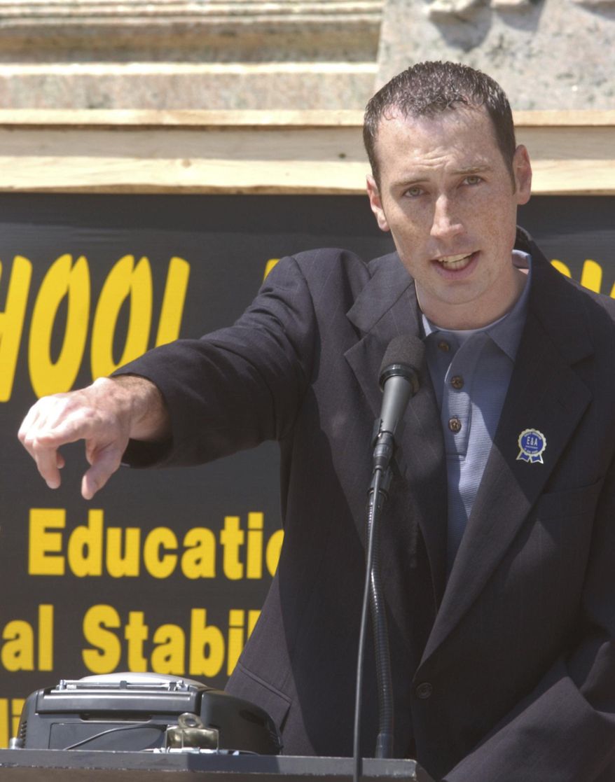 FILE – In this May 5, 2004, file photo, Nathan DeRolph, who in 1991 started the original lawsuit that led to an Ohio Supreme Court ruling that the state's school funding system was unconstitutional, gestures during a school funding rally at the Ohio Statehouse in Columbus, Ohio. Twenty years after justices ruled 4-3 in the case DeRolph v. State on March 24, 1997, hundreds of new school buildings dot the landscape and the notion of what constitutes an adequate education is regularly debated in U.S. state capitals. (AP Photo/Paul Vernon, File)