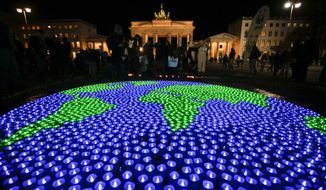 A globe illuminated with led-lights by activists of the World Wide Fund For Nature (WWF) in front of the Brandenburg Gate to mark Earth Hour, in Berlin, Saturday, March 25, 2017. (AP Photo/Markus Schreiber) ** FILE **