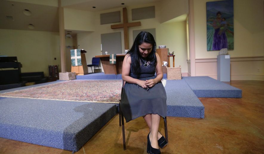 In this Wednesday, Feb. 22, 2017 photo, Hilda Ramirez, an immigrant living illegally in the U.S, sits in the sanctuary at St. Andrew's Presbyterian Church as she waits to talk to a reporter, Wednesday, in Austin, Texas. Ramirez, from Guatemala, and her son have taken refuge at the church for more than a year. (AP Photo/Eric Gay)