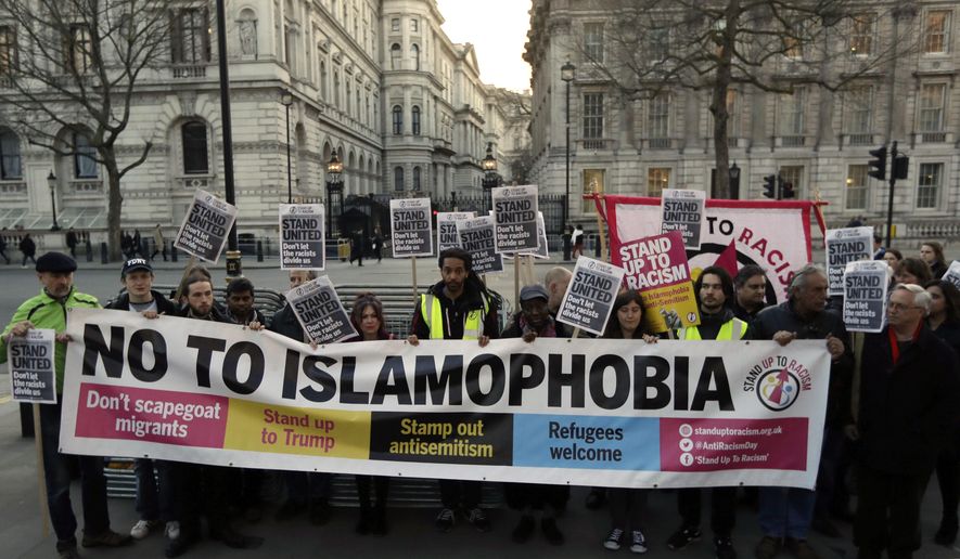 People hold up a banner during a &#x27;Unity Vigil&#x27; against racism and Islamophobia in reaction to Wednesday&#x27;s attack, backdropped by the gates of Downing Street in London, Friday March 24, 2017. On Thursday authorities identified a 52-year-old Briton as the man who mowed down pedestrians and stabbed a policeman to death outside Parliament in London, saying he had a long criminal record and once was investigated for extremism — but was not currently on a terrorism watch list. (AP Photo/Matt Dunham)