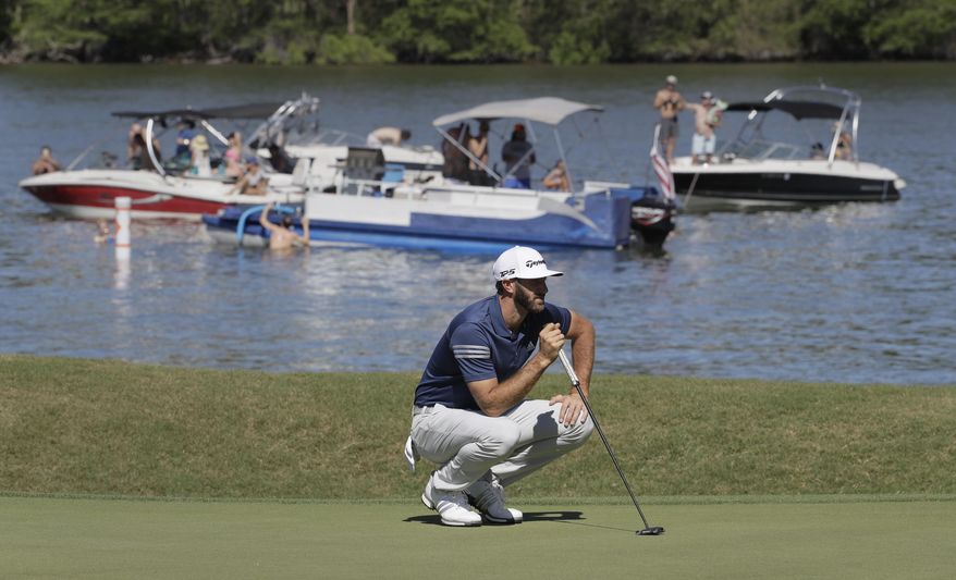 Dustin Johnson lines up a putt on the 14th hole as fans watch from boats on Lake Austin during quarterfinal play at the Dell Technologies Match Play golf tournament at Austin County Club, Saturday, March 25, 2017, in Austin, Texas. (AP Photo/Eric Gay)