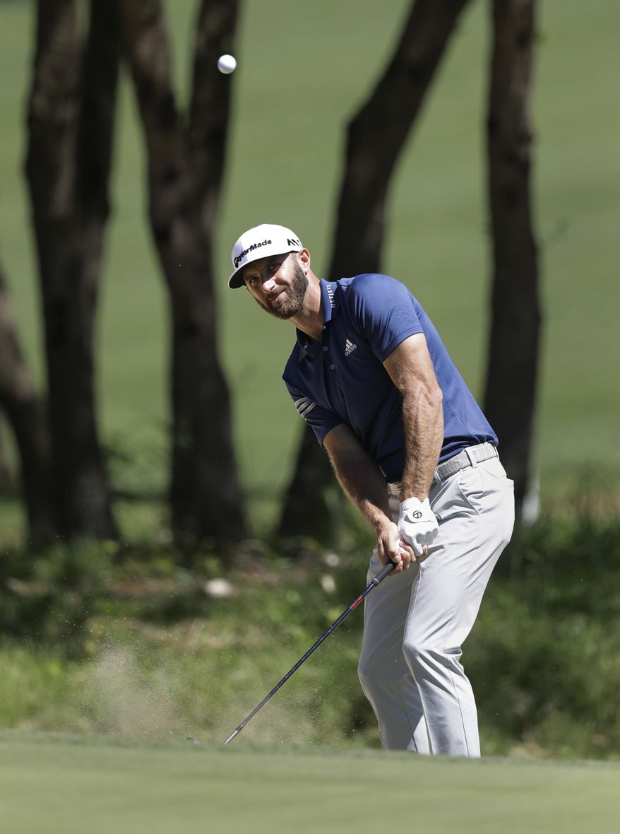Dustin Johnson chips to the green on the seventh hole during quarterfinal play at the Dell Technologies Match Play golf tournament at Austin County Club, Saturday, March 25, 2017, in Austin, Texas. (AP Photo/Eric Gay)