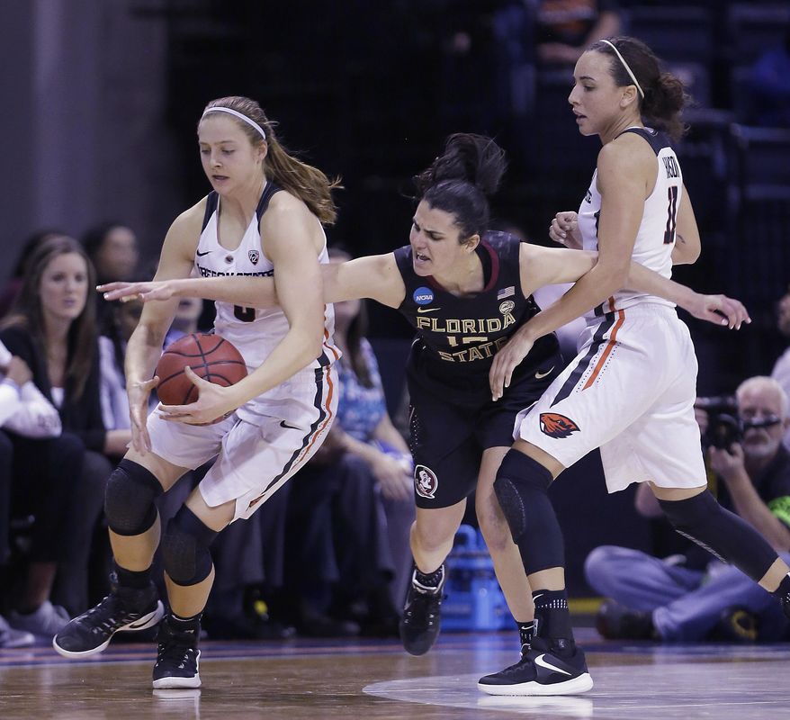Florida State guard Leticia Romero, center, battles for the ball with Oregon State's Mikayla Pivec, left, and Gabriella Hanson during the second half of a regional semi-final round game of an NCAA college basketball tournament, Saturday, March 25, 2017, in Stockton, Calif. Florida State won 66-53. (AP Photo/Rich Pedroncelli)