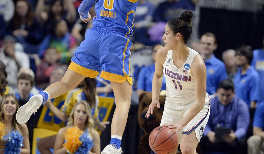 UCLA&#x27;s Nicole Kornet, left, leaps in the air as she guards Connecticut&#x27;s Kia Nurse, right, during the first half of a regional semifinal game in the NCAA women&#x27;s college basketball tournament, Saturday, March 25, 2017, in Bridgeport, Conn. (AP Photo/Jessica Hill)