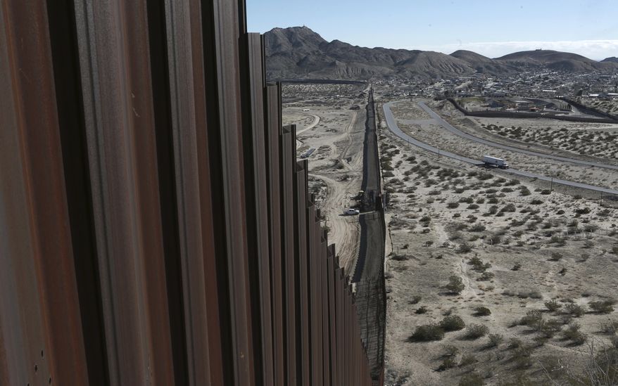 This Jan. 25, 2017, file photo shows a truck driving near the Mexico-U.S. border fence, on the Mexican side, separating the towns of Anapra, Mexico and Sunland Park, New Mexico. (AP Photo/Christian Torres, File)