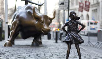 In this March 22, 2017 photo, the Charging Bull and Fearless Girl statues are sit on Lower Broadway in New York. Since 1989 the bronze bull has stood in New York City&#x27;s financial district as an image of the might and hard-charging spirit of Wall Street. But the installation of the bold girl defiantly standing in the bull&#x27;s path has transformed the meaning of one of New York&#x27;s best-known public artworks. Pressure is mounting on the city to let the Fearless Girl stay. (AP Photo/Mark Lennihan)