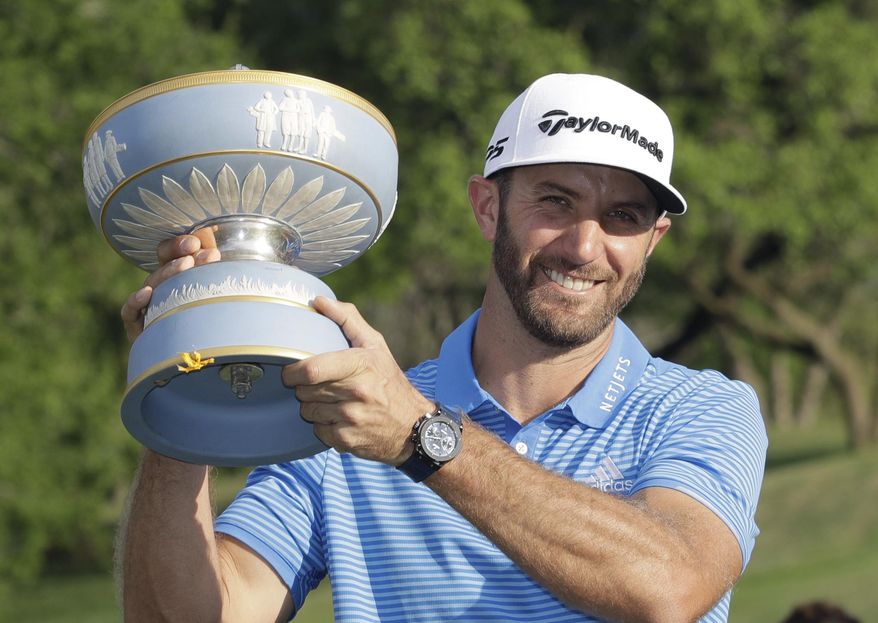 Dustin Johnson holds his trophy after defeating Jon Rahm of Spain at the Dell Technologies Match Play golf tournament at Austin County Club, Sunday, March 26, 2017, in Austin, Texas. (AP Photo/Eric Gay)