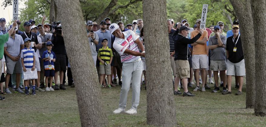 Hideto Tanihara of Japan watches his shot from the trees on the first hole during semifinal play at the Dell Technologies Match Play golf tournament at Austin County Club, Sunday, March 26, 2017, in Austin, Texas. (AP Photo/Eric Gay)