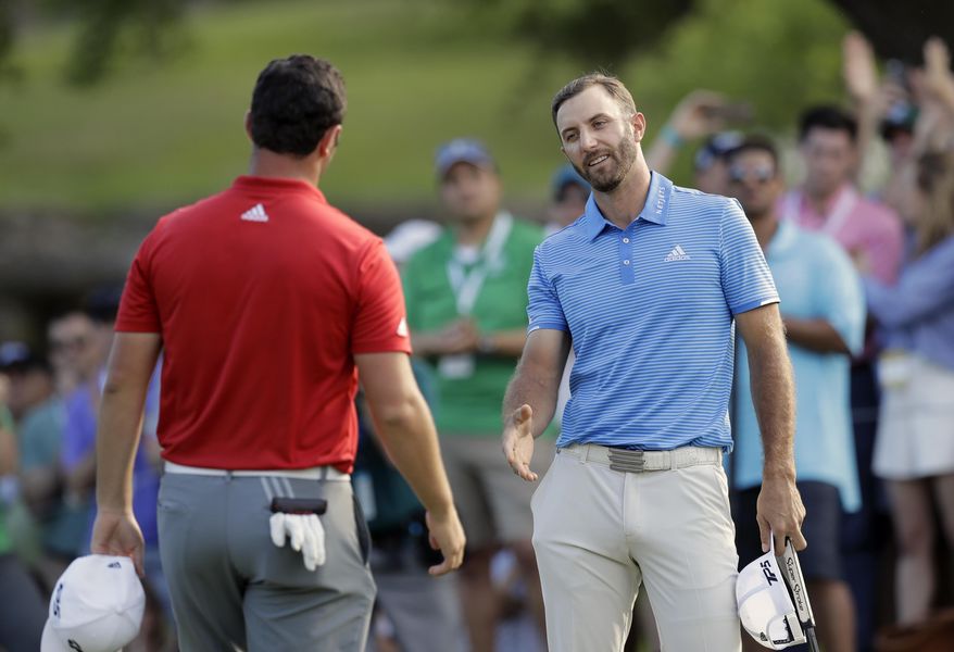 Dustin Johnson, right, reaches out to Jon Rahm, left, of Spain, after Johnson&#39;s win in the final pairing of the Dell Technologies Match Play golf tournament at Austin County Club, Sunday, March 26, 2017, in Austin, Texas. (AP Photo/Eric Gay)