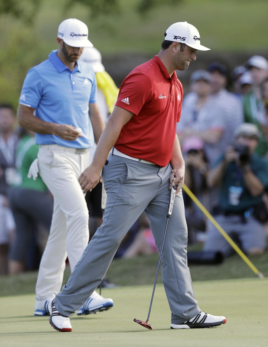 Jon Rahm of Spain, right, reacts as he falls to Dustin Johnson in the final round at the Dell Technologies Match Play golf tournament at Austin County Club, Sunday, March 26, 2017, in Austin, Texas. (AP Photo/Eric Gay)