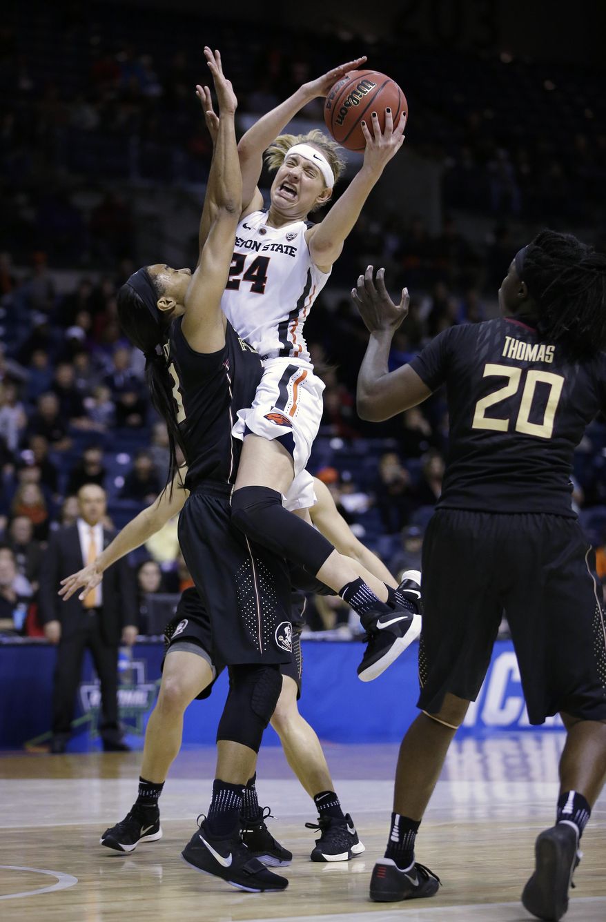 Oregon State guard Sydney Wiese, center, crashes into Florida State forward Ivey Slaughter, left, and called for a charging foul during the second half of a regional semi-final round game of an NCAA college basketball tournament, Saturday, March 25, 2017, in Stockton, Calif. Florida State won 66-53. (AP Photo/Rich Pedroncelli)