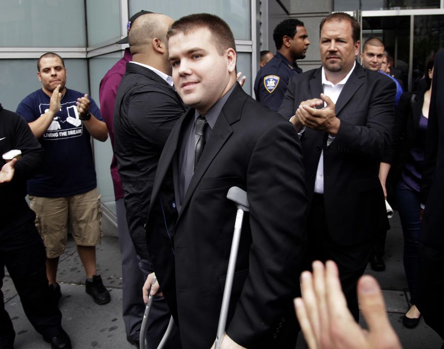FILE - In this June 13, 2012, file photo, police officers and supporters clap as Officer Richard Haste, center, exits the courthouse after posting bail in New York. Haste, a white police officer who fatally shot an unarmed black teenager, resigned Sunday, March 26, 2017, from the New York Police Department to avoid being fired following a disciplinary trial. He was brought on departmental charges for demonstrating "poor judgment" by not taking obvious steps to defuse a fatal standoff with Ramarley Graham. (AP Photo/Seth Wenig, File)