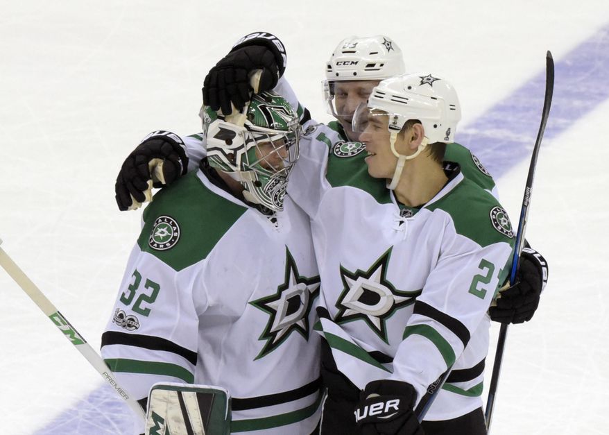 Dallas Stars goalie Kari Lehtonen (32) celebrates with Adam Cracknell, right, and Esa Lindell (23) after the Stars defeated the New Jersey Devils 2-1 in overtime in an NHL hockey game Sunday, March 26, 2017, in Newark, N.J. (AP Photo/Bill Kostroun)