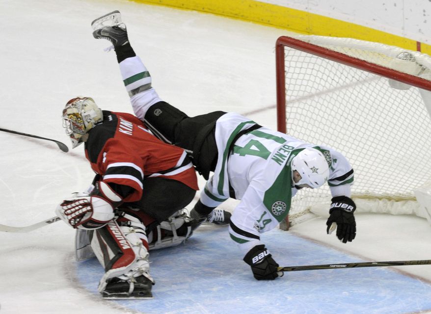 Dallas Stars left wing Jamie Benn (14) falls over New Jersey Devils goalie Keith Kinkaid (1) during the second period of an NHL hockey game Sunday, March 26, 2017, in Newark, N.J. (AP Photo/Bill Kostroun)