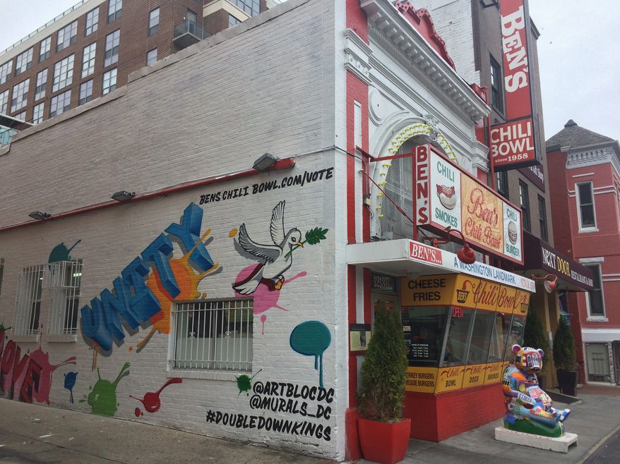 A temporary mural was painted on the side of Ben's Chili Bowl on U Street directing people to the restaurant's website, where they can vote for famous politicians, athletes and entertainers to be featured in the new mural. (Julia Brouillette/The Washington Times)