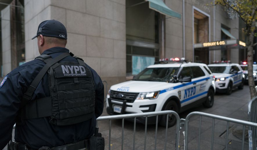 An NYPD counterterrorism officer secures a barricade near Trump Tower in New York Wednesday, Nov. 9, 2016. Donald Trump claimed his place Wednesday as America's 45th president, an astonishing victory for the celebrity businessman and political novice who capitalized on voters' economic anxieties, took advantage of racial tensions and overcame a string of sexual assault allegations on his way to the White House. (AP Photo/Craig Ruttle)
