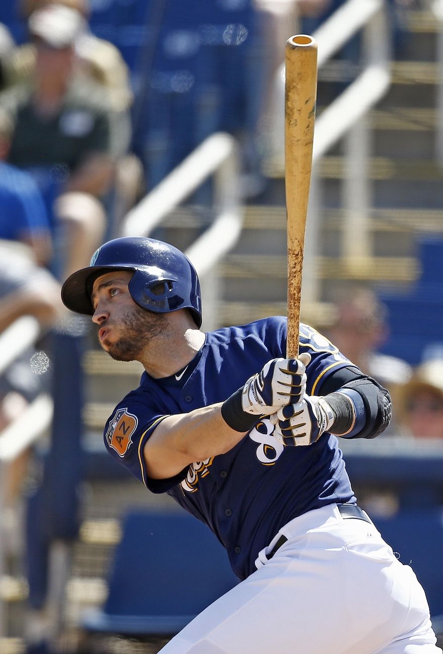 FILE - In this March 17, 2017, file photo, Milwaukee Brewers left fielder Ryan Braun watches the flight of his two-run home run against the Kansas City Royals during the first inning of a spring training baseball game, in Phoenix. Braun is back in left after bouncing back in 2016 to hit .305 with 30 homers, 91 RBIs and 16 steals. Now the team’s longest-tenured player, the 33-year-old Braun is starting the season healthy for the first time in a few years. (AP Photo/Ross D. Franklin, File)