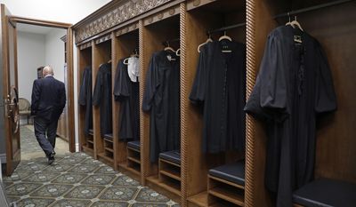 A man walks through the robing room during a tour of the new Nevada Supreme Court, Monday, March 27, 2017, in Las Vegas. Officials marked the opening of a new Nevada Supreme Court building in downtown Las Vegas that has offices and chambers for state high court justices and appellate judges, and a larger courtroom for arguments. (AP Photo/John Locher)
