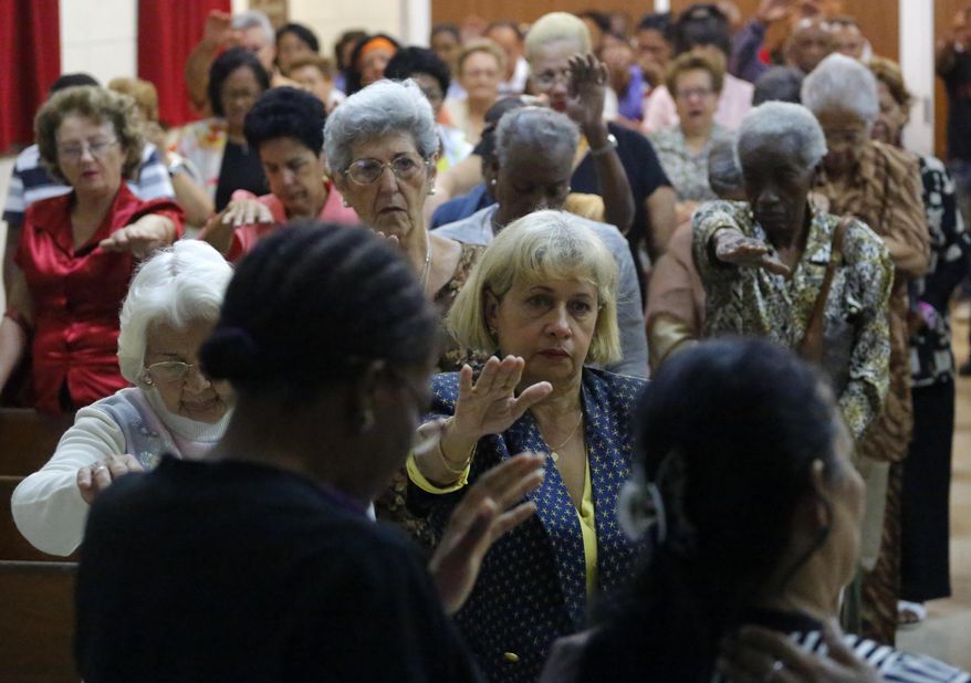 In this March 19, 2017 photo, people attend Sunday worship at the William Carey Baptist Church in Havana, Cuba. Churches are working on projects that once would have been forbidden to them, including efforts on HIV-AIDS prevention, sustainable agriculture, renewable energy, medicine distribution, training of farm workers and disaster relief.(AP Photo/Desmond Boylan)