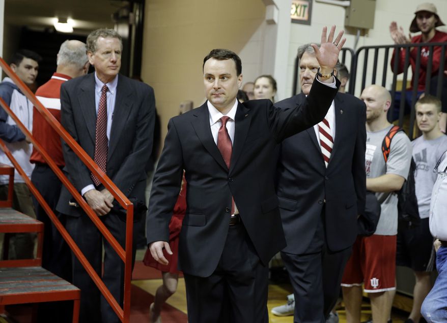 New Indiana NCAA college basketball coach Archie Miller waves as he walks on to the court of Assembly Hall before he was introduced during a news conference on the court in Bloomington, Ind., Monday, March 27, 2017. Miller was the head coach at Dayton. (AP Photo/Michael Conroy)