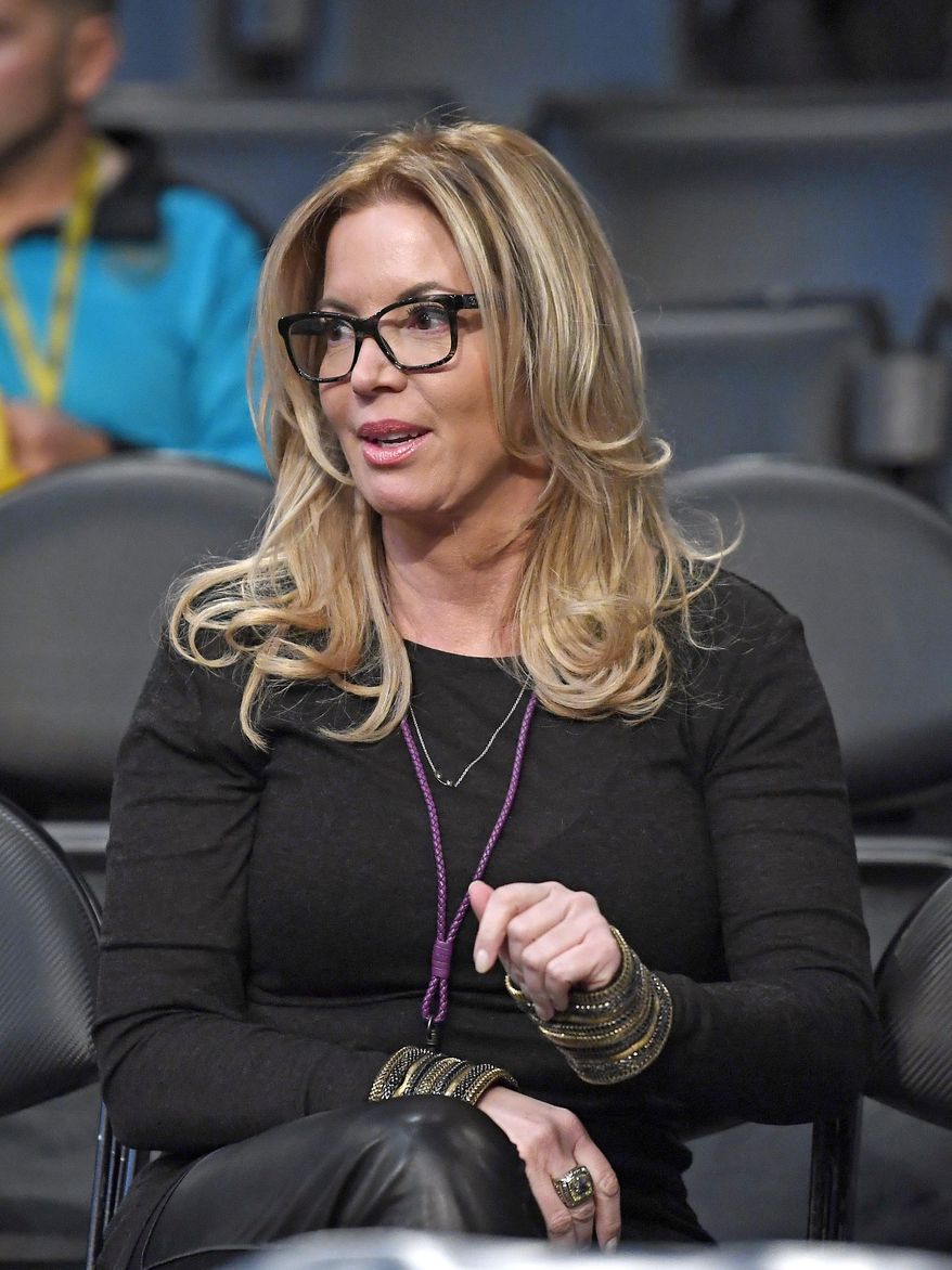 FILE - In this March 3, 2017 file photo, Los Angeles Lakers president Jeanie Buss sits in the stands prior to an NBA basketball game between the Lakers and the Boston Celtics in Los Angeles. A battle over control of the Lakers is over after an agreement was reached to have Jeanie Buss serve as controlling owner of the storied NBA franchise. Documents filed Monday, March 27, 2017 in Los Angeles Superior Court state that Jim and Johnny Buss have agreed that their sister will serve as the controlling owner for the rest of her life. (AP Photo/Mark J. Terrill, File)