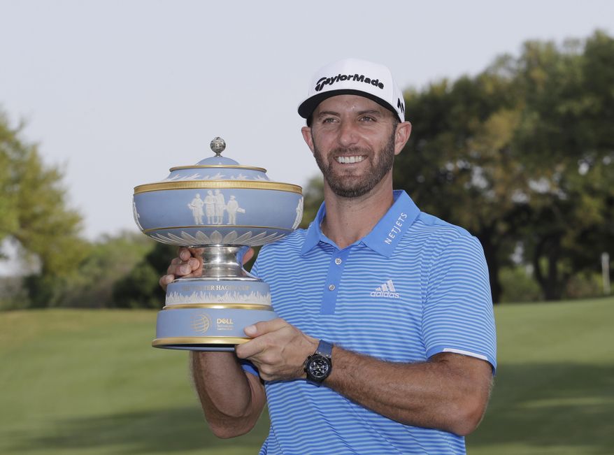 Dustin Johnson poses with his trophy after defeating Jon Rahm, of Spain, at the Dell Technologies Match Play golf tournament at Austin County Club, Sunday, March 26, 2017, in Austin, Texas. (AP Photo/Eric Gay)