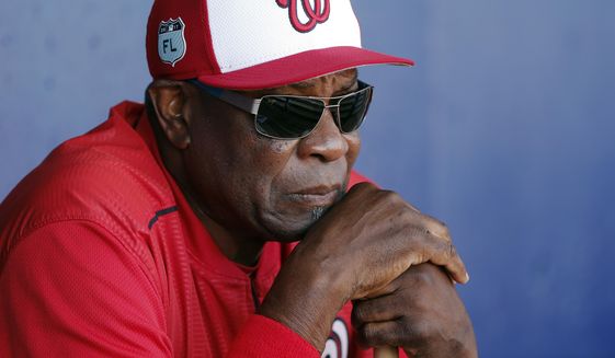 In this March 11, 2017, file photo, Washington Nationals manager Dusty Baker (12) talks to reporters in the dugout before playing New York Mets in a spring training baseball game, in Port St. Lucie, Fla. (AP Photo/John Bazemore, File)