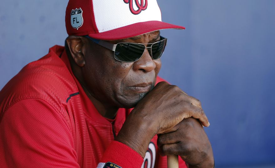 In this March 11, 2017, file photo, Washington Nationals manager Dusty Baker (12) talks to reporters in the dugout before playing New York Mets in a spring training baseball game, in Port St. Lucie, Fla. (AP Photo/John Bazemore, File)