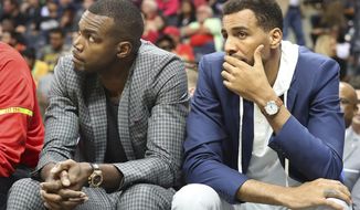 Injured Atlanta Hawks forward Paul Millsap, left, and guard Thabo Sefolosha watch from the bench as the Hawks fall 107-92 to the Brooklyn Nets in an NBA basketball game Sunday, March 26, 2017, in Atlanta. It is the Hawks seventh consecutive loss and the fifth consecutive game Millsap has missed. (Curtis Compton/Atlanta Journal-Constitution via AP)