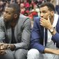 Injured Atlanta Hawks forward Paul Millsap, left, and guard Thabo Sefolosha watch from the bench as the Hawks fall 107-92 to the Brooklyn Nets in an NBA basketball game Sunday, March 26, 2017, in Atlanta. It is the Hawks seventh consecutive loss and the fifth consecutive game Millsap has missed. (Curtis Compton/Atlanta Journal-Constitution via AP)