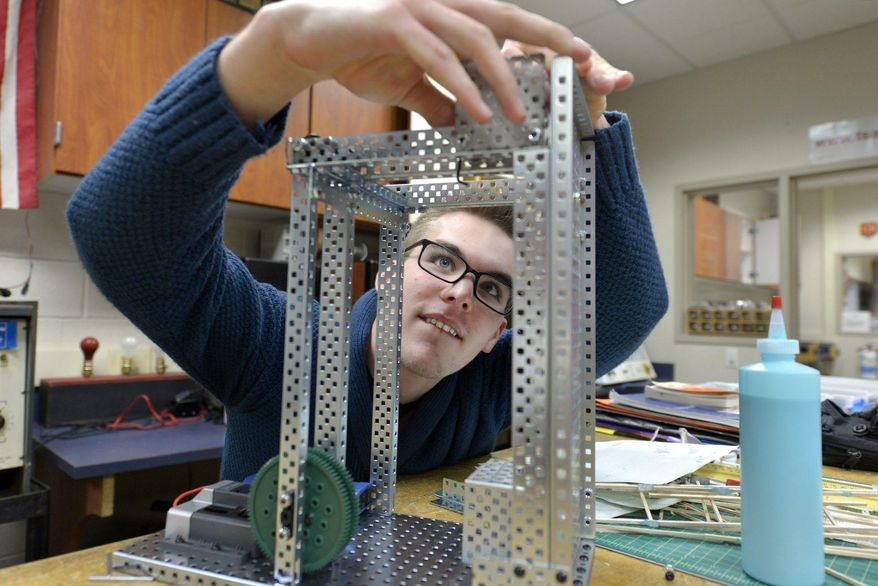 In a Feb.19, 2017 photo, Patryk Smith tests his elevator in the robotics room as part of the mass customized learning program at Pequea Valley High School in Kinzers, Pa. In October, 180 educators from around the state gathered in Lancaster for presentations and tours of the district's schools. (Richard Hertzler/LNP via AP)