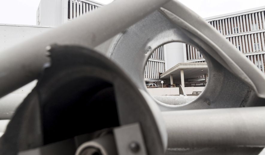 In a Friday, March 24, 2017 photo, the old entrance to the Lied Renaissance Center building is framed between dismantled light posts in Omaha, Neb. Demolition of the Lied Renaissance Center, formerly Methodist Midtown Hospital, began in mid-March and is expected to be completed by late June. By summertime, the new Salvation Army building at 36th and Cuming Streets will no longer be in the shadow of its 110-year-old predecessor. (Matt Miller/The World-Herald via AP)