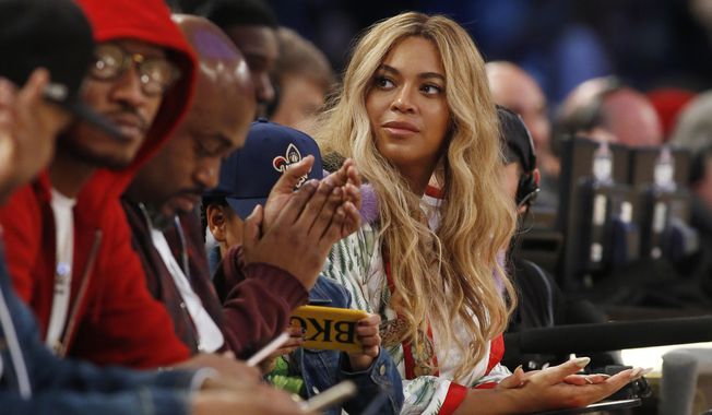 FILE - In this  Feb. 19, 2017. file photo, Beyonce sits at court side during the second half of the NBA All-Star basketball game in New Orleans. A Houston high school student lost her battle with cancer on March 25, 2017, days after receiving a FaceTime call from the singer. (AP Photo/Max Becherer, File)