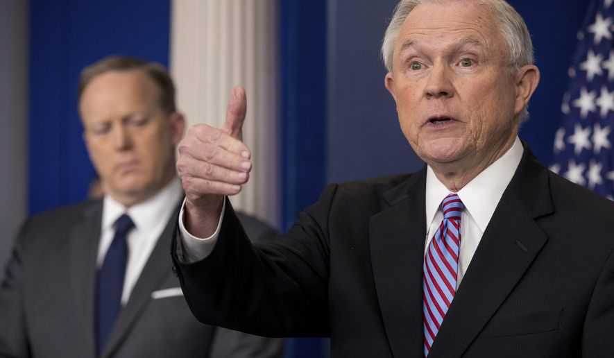 Attorney General Jeff Sessions, right, accompanied by White House press secretary Sean Spicer, talks to the media during the daily press briefing at the White House in Washington, Monday, March 27, 2017. (AP Photo/Andrew Harnik)