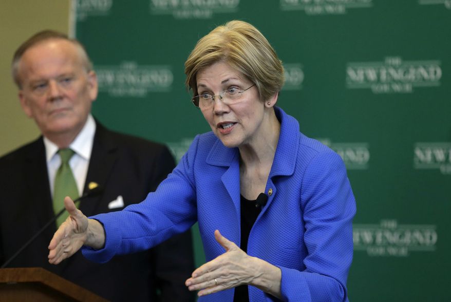 U.S. Sen. Elizabeth Warren, D-Mass., right, addresses business leaders during a New England Council luncheon as Jim Brett, left, president and CEO of the council, looks on at a hotel, Monday, March 27, 2017, in Boston. (AP Photo/Steven Senne)