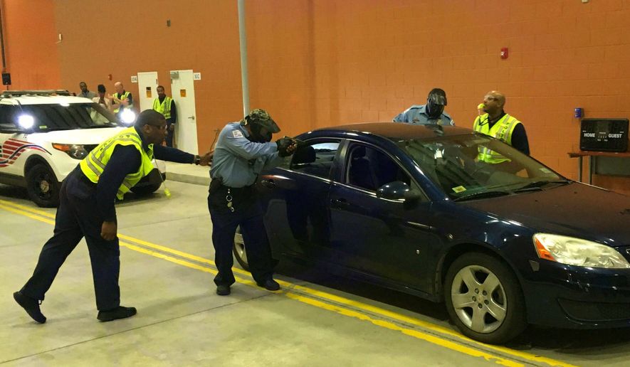 D.C. police trainers and cadets conduct a tactical demonstration of a traffic stop Tuesday at the Metropolitan Police Academy in Southwest. The Metropolitan Police Department wants to double its cadet class. (Ryan M. McDermott/The Washington Times)