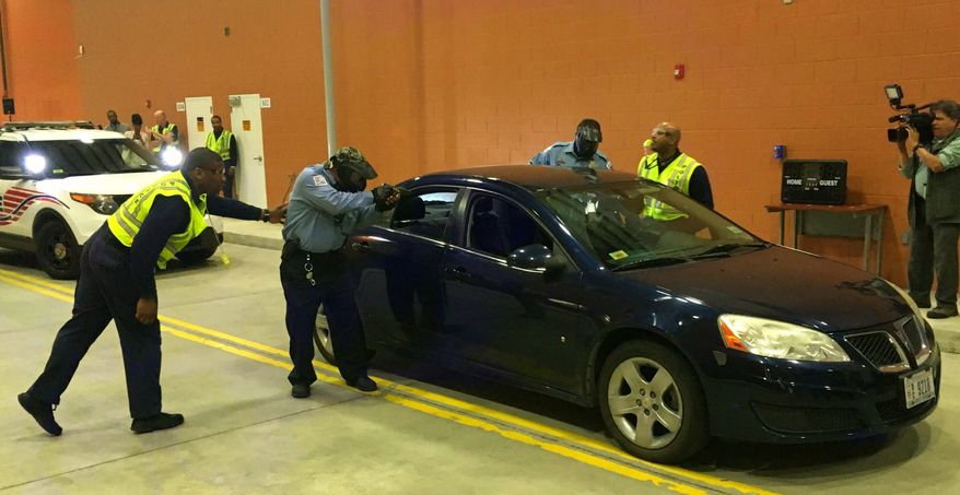 D.C. police trainers and cadets conduct a tactical demonstration of a traffic stop Tuesday at the Metropolitan Police Academy in Southwest. The Metropolitan Police Department wants to double its cadet class. (Ryan M. McDermott/The Washington Times)