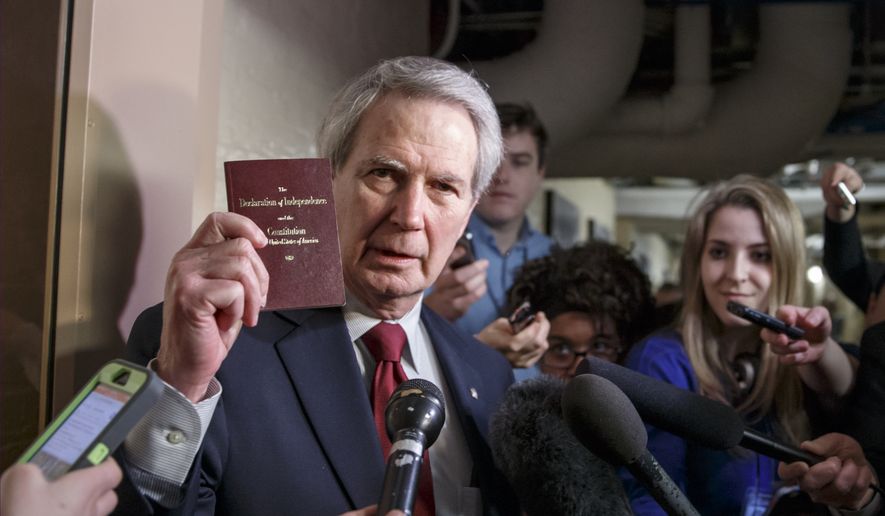 Rep. Walter B. Jones, R-N.C., holds up a copy of the Constitution while talking to reporters as House Republicans emerge from a closed-door meeting on how to deal with the impasse over the Homeland Security budget, at the Capitol in Washington, Thursday, Feb. 26, 2015.  GOP lawmakers have been trying to block President Barack Obama&#39;s executive actions on immigration through the funding for the DHS which expires Friday night. Sounding retreat, House Republicans agreed Thursday night to push short-term funding to prevent a partial shutdown at the Department of Homeland Security while leaving in place Obama administration immigration policies they have vowed to repeal.   (AP Photo/J. Scott Applewhite)