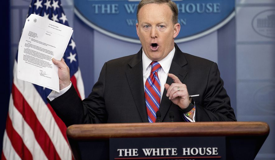 White House press secretary Sean Spicer holds up a document concerning a Washington Post story on Sally Yates as he talks to the media during the daily press briefing at the White House in Washington Tuesday, March 28, 2017. Spicer discussed the Supreme Court nominee Justice Neil Gorsuch, jobs, healthcare, and other topics. (AP Photo/Andrew Harnik)