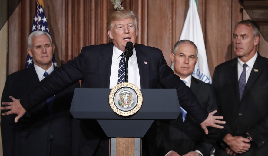 President Donald Trump, accompanied by from left, Vice President Mike Pence, Environmental Protection Agency (EPA) Administrator Scott Pruitt, and Interior Secretary Ryan Zinke, speaks at EPA headquarters in Washington, Tuesday, March 28, 2017, prior to signing an Energy Independence Executive Order. Trump signed an executive order aimed at moving forward on his campaign pledge to unravel former President Barack Obama&#39;s plan to curb global warming. (AP Photo/Pablo Martinez Monsivais)
