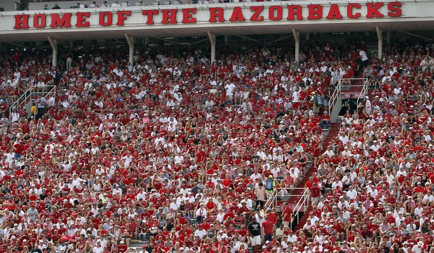 FILE  - In this Sept. 5, 2015, file photo, Arkansas fans cheer on the Hogs during an NCAA college football game against UTEP at Donald W. Reynolds Razorback Stadium in Fayetteville, Ark. The Southeastern Conference said Tuesday, March 28, 2017, it wants Arkansas lawmakers to exempt college sporting events such as football games from a new law greatly expanding where concealed handguns are allowed, citing concerns about safety at its games.  (AP Photo/Samantha Baker, File)