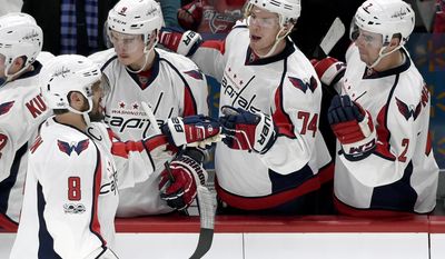 Washington Capitals left wing Alex Ovechkin (8), of Russia, is congratulated by Dmitry Orlov (9), of Russia, John Carlson (74) and Matt Niskanen (2) on scoring a goal against the Minnesota Wild on the power play during the second period of an NHL hockey game, Tuesday, March 28, 2017, in St. Paul, Minn. (AP Photo/Hannah Foslien)